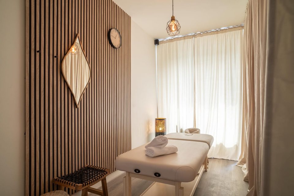 Massage room with a table and wooden panelling