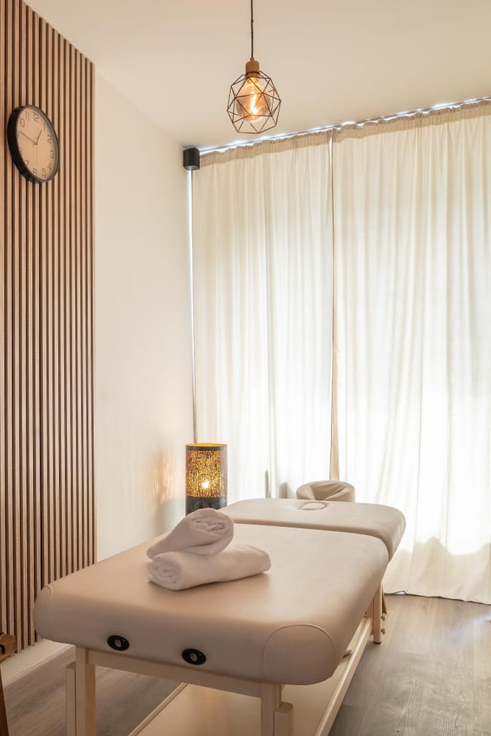 Massage table by the window with curtains